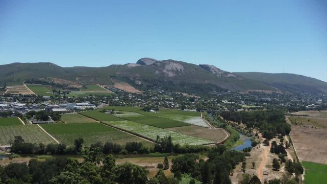  Camera panning up over Paarl Town South Africa with the iconic Paarl rock behind the town 4K Aerial Video