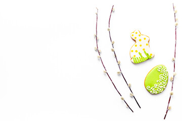 Easter homemade bunny cookies and eggs with willow branches, top view