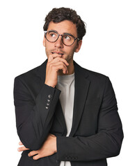 Young Hispanic businessman relaxed thinking about something looking at a copy space.