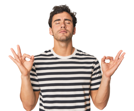 Young Hispanic man in studio relaxes after hard working day, she is performing yoga.