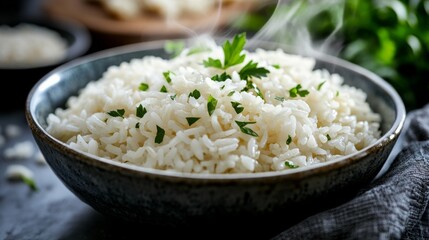 Close-up of a bowl of cooked rice. Featuring fluffy white rice with steam rising. Emphasizing the texture and appetizing appearance. Ideal for recipes and food presentations.