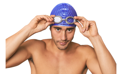 Close-up of Hispanic male swimmer with goggles, winner's attitude