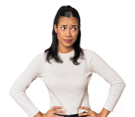 Young Filipina woman confused, feels doubtful and unsure.