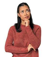 Young Filipina woman thinking and looking up, being reflective, contemplating, having a fantasy.