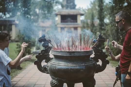 Man and boy praying at temple, Thien Mu Pagoda, Thua Thien Hue, Vietnam