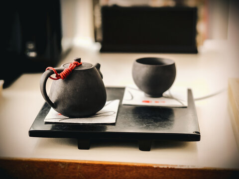 Close-up of a traditional Asian teapot and teacup on a table for a Chinese tea ceremony