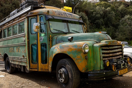 Vintage green yellow old timer school bus repurposed as mobile home travel camper van 