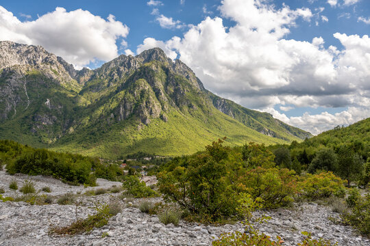 Scenic view of the Blue Eye of Theth hiking path in Albania with mountains and greenery