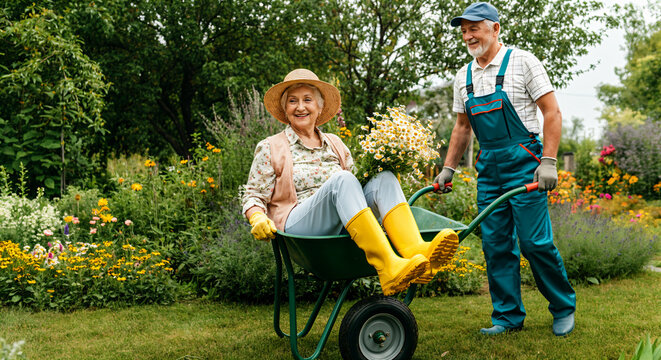 old people having fun in their own sdu. Man pushing woman in garden cart
