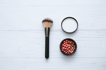 professional brush and blush balls on white wooden background. Make up, beauty and cosmetics concept, copy space for your text.