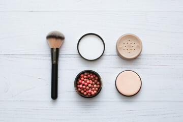 professional brush, powder and blush balls on white wooden background. Make up, beauty and cosmetics concept, copy space for your text.