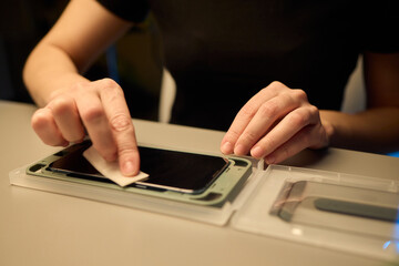 Fototapeta premium To apply a screen protector onto your smartphone, you will need to have focus, care, and precision