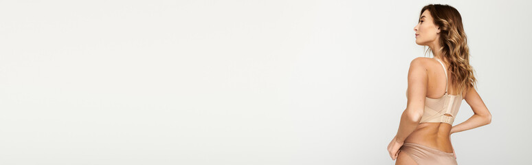 Beautiful young woman showcasing elegant lingerie in a minimalist setting with style and grace