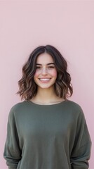 Fototapeta premium Smiling Young Woman in Green Sweater Against Pink Background