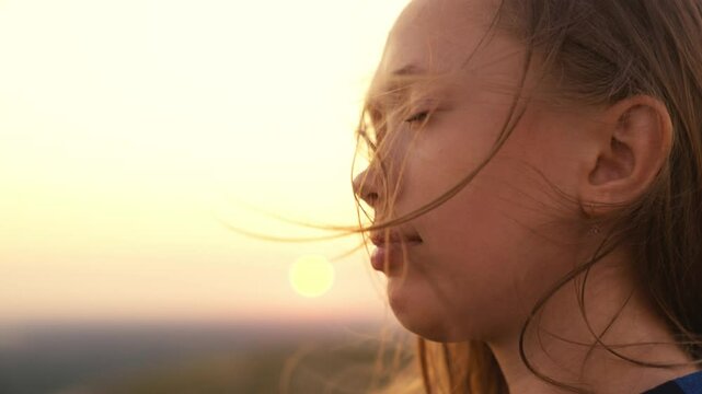 girl with long hair wind. smile child girl sunset. person breathes fresh air. eco. girl dream. teenager pray dawn. beautiful face long-haired girl wind close-up. clean air concept. breath nature park.