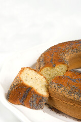 Ciambellone con semi di papavero or donut with poppy seeds on white background