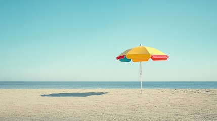 A vibrant beach umbrella in shades of red, yellow, and blue, standing out against the sunny beach and clear sky