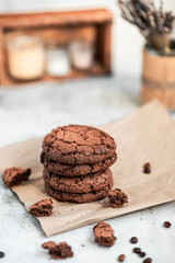 American chocolate chip cookies with coffee, handmade cookies, homemade baking, kraft paper, cookie packaging, macro cookie texture, warm light composition, selected focus, still life, food photograph