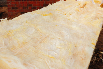 Construction site displaying insulation material laid out for installation in a building project 