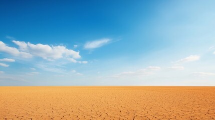 Naklejka premium Understanding Environmental Impact: Climate Change and Pollution Awareness, Vast sandy landscape under a clear blue sky with scattered clouds.