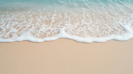 Gentle waves lap against soft sand, creating serene coastal atmo