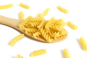 A pile of dry pasta lies on a wooden spoon on a white background.