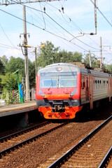 Obraz premium In summer, the electric train stands at the station. 