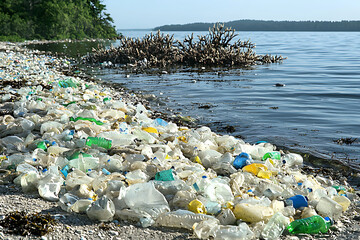 A stark image depicting a shoreline littered with plastic waste, highlighting the devastating impact of pollution on our oceans.