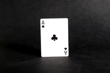On a black background there is a playing card, the ace of spades.