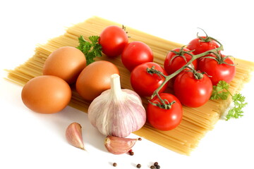 On a white background there are long pasta with different vegetables and a chicken egg.
