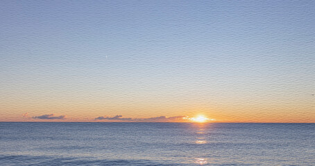 The sky is blue and the sun is setting