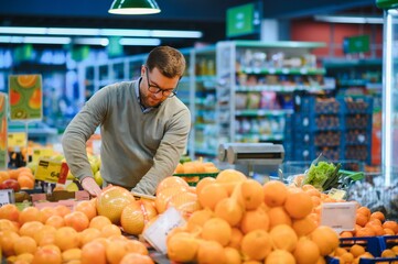 Man buying vegetables and fruit in grocery store, zero waste concept