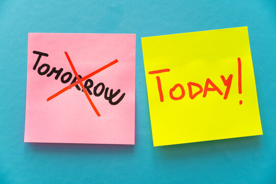 Colored card, with the word Tomorrow crossed out, and next to it cards with the word Today. Procrastination and postponement.