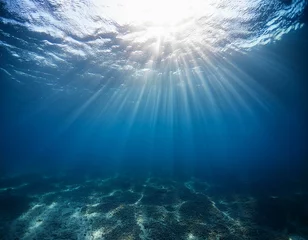 Fototapete Rund shining light rays under water of blue ocean background © Joseph