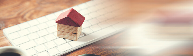 keyboard with house model on office desk