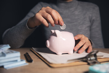 Businesswoman save money in piggy bank