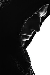 A person wearing a hooded jacket looks down, possibly lost or introspective