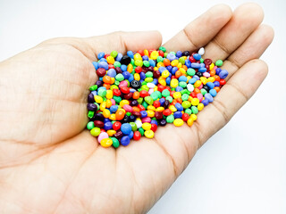 Plastic masterbatch mix color granules in open hand grip, polymer carrying colorful pigments...