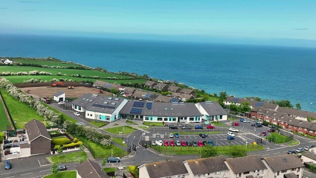 Slow motion Aerial view of Corran Integrated Primary School and Nursery Larne Irish Sea County Antrim Northern Ireland