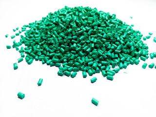 Green masterbatch plastic granules, polymer carries colorful pigments poured into a white background, suitable for product catalog design of industrial plastic manufacturing company profiles