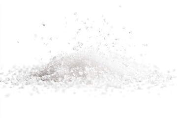 A pile of sugar on a white surface, ideal for food photography or graphic design