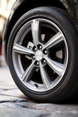 Obraz premium A close-up shot of a car tire with tread and no road or car in sight