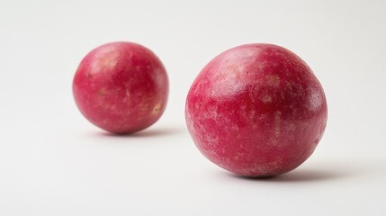 Obraz premium Close-up of two red apples sitting side by side on a white surface