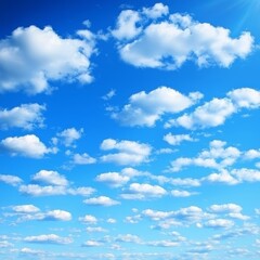 Obraz premium Bright blue sky dotted with fluffy, white cumulus clouds, bathed in sunlight from the upper right corner -ai