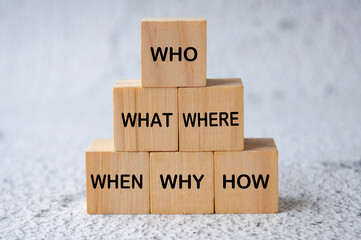 Who, What, Where, When, Why and How text on wooden cubes. Fact finding concept