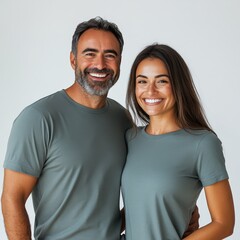 Fototapeta premium Smiling Couple in Casual T-Shirts Posing Together Against Wall
