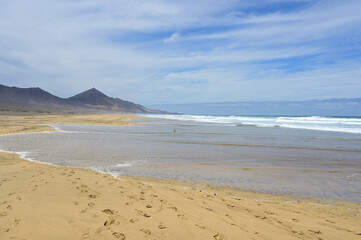 Panorama of the endless lonely nature sand beach of playa Cofete by the atlantic coast. Fuerteventura, Canary Islands, Spain