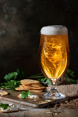 Glass of beer against a dark wall