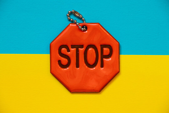Flag of Ukraine and reflective keychain with text stop - Powered by Adobe