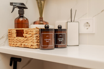 Organization of space on the sink in the bathroom. Decor and containers for patches
